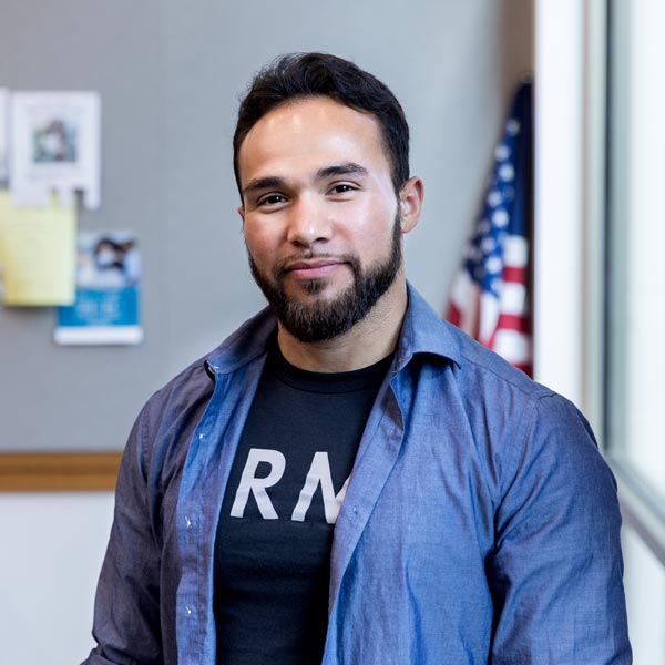 Army vet poses for portrait in front of American flag