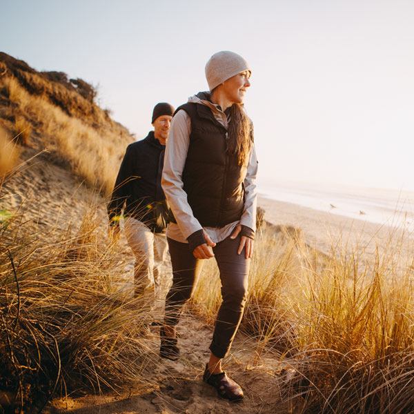 A senior couple explores a beach